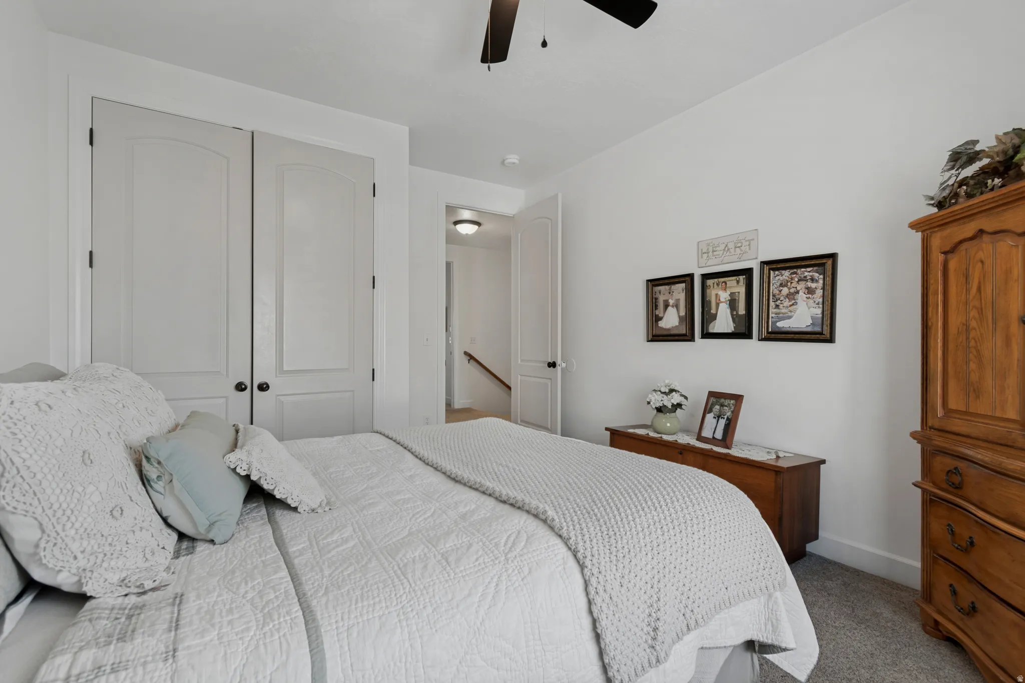 Integrated ceiling fan, white interior doors with black hardware, and carpeted flooring