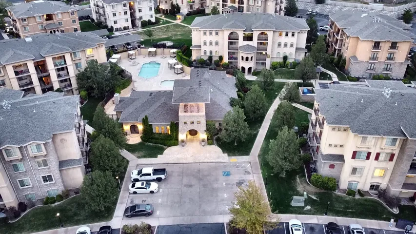 Clubhouse aerial views. Building exteriors featuring stone accents, balconies, and multiple windows
