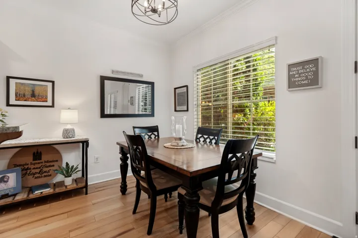 LVP flooring, crown molding, a window with blinds, and a built-in light fixture