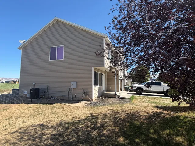 Exterior featuring horizontal siding, a gabled roofline, and a paved driveway