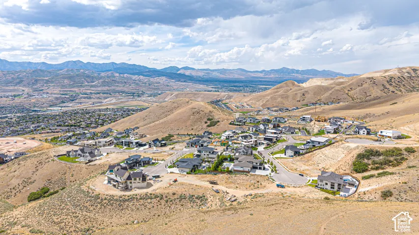 Expansive residential development nestled into mountainous terrain with established homes and undeveloped lots