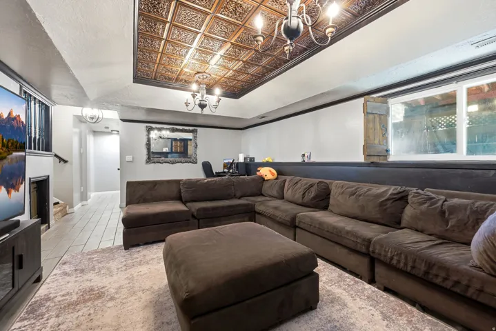 Recessed ceiling with decorative paneling and central chandelier