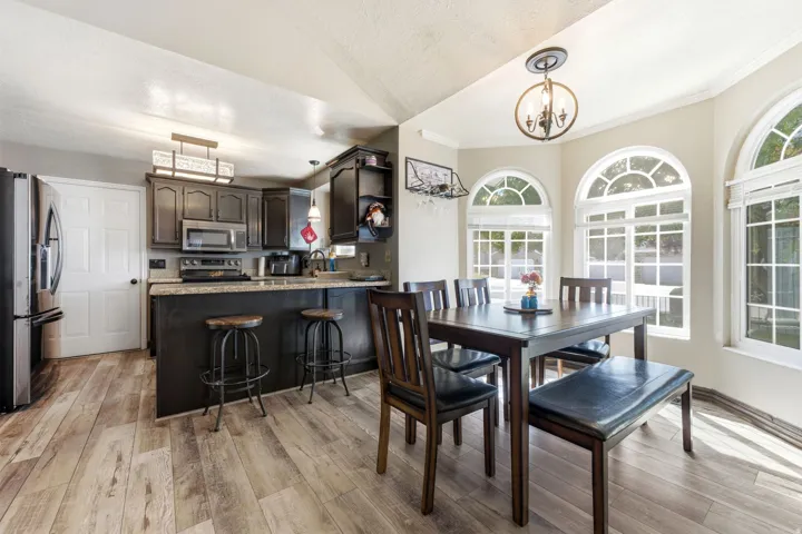 Kitchen featuring stainless steel appliances, dark wood-finish cabinetry, and a breakfast bar