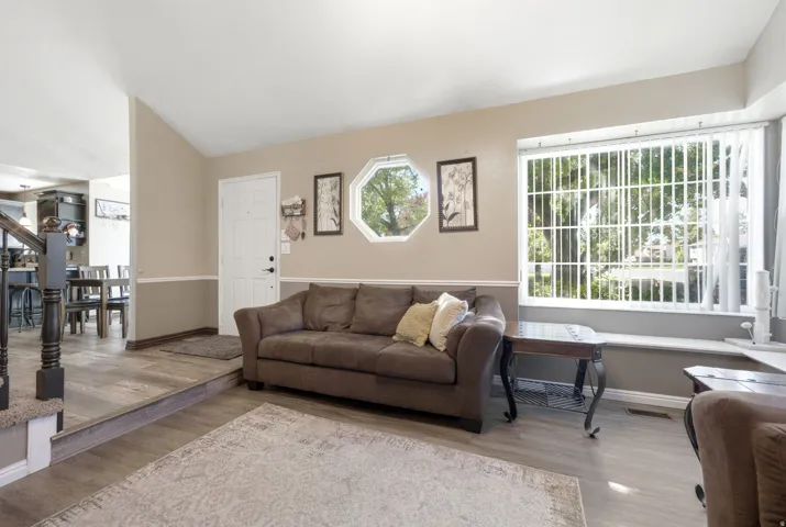 Wood-finish flooring throughout, complemented by a front entry door with paneling