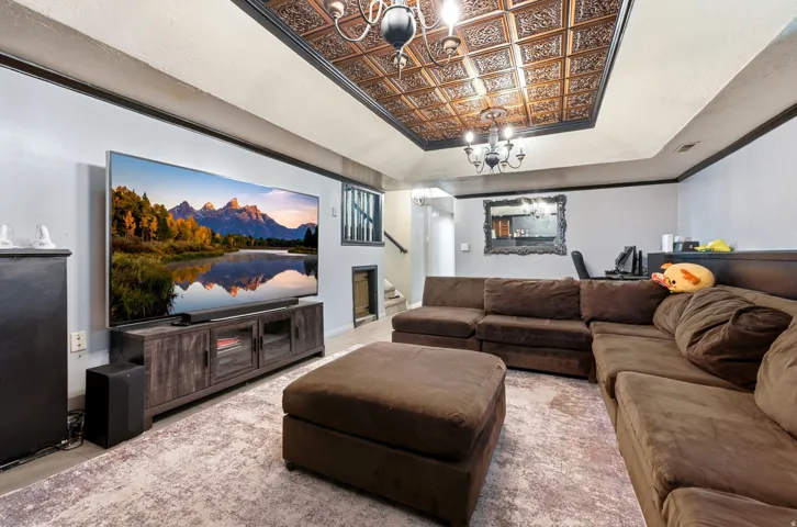 Coffered ceiling with decorative panels and chandelier lighting