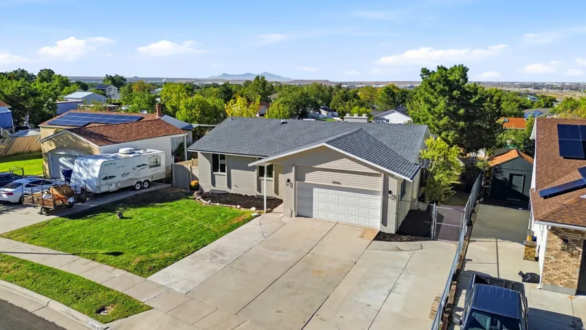 Single-story residence featuring a two-car garage, concrete driveway, and front lawn