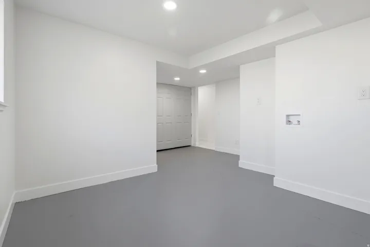 Neutral paint palette with recessed lighting and a window offering natural illumination