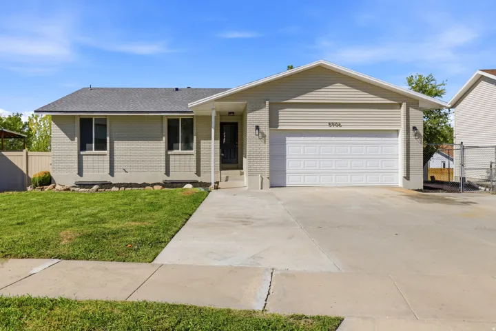 Light gray brick exterior with a contrasting white garage door