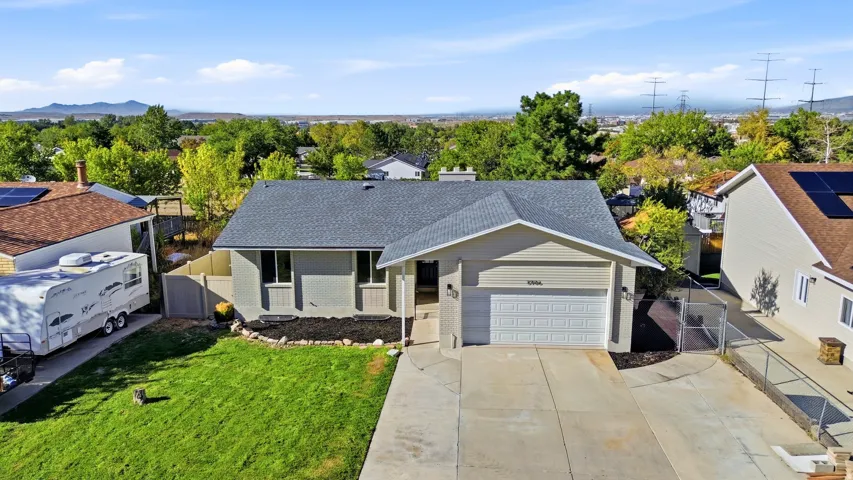 Single-story residence featuring a two-car garage, concrete driveway, and a shingle roof