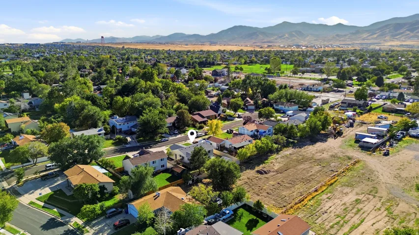 Aerial perspective of a residential neighborhood with a mountain backdrop