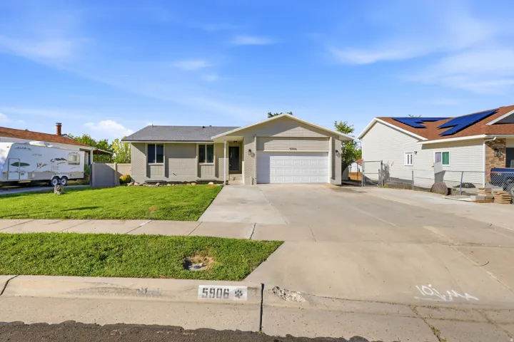 Single-story residence featuring a two-car garage, concrete driveway, and a front walk