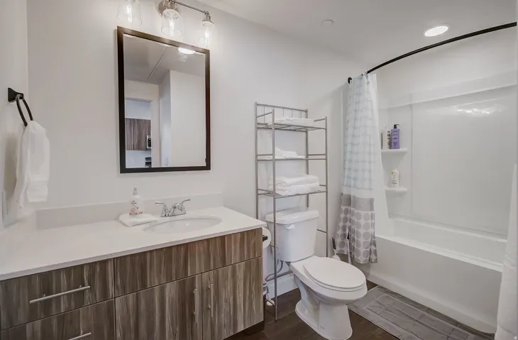 Bathroom featuring a vanity with wood-finish cabinetry, a white countertop, and a built-in sink
