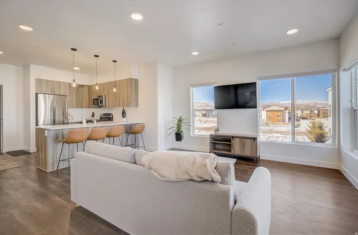 Open-concept living space featuring wood-finish flooring and recessed lighting