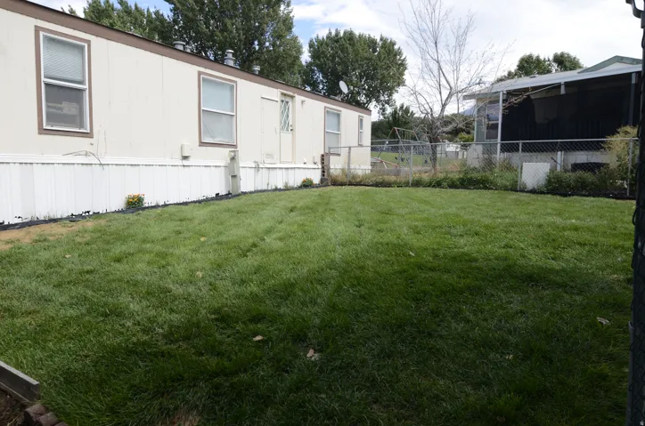 Expansive grassy area with chain link fencing