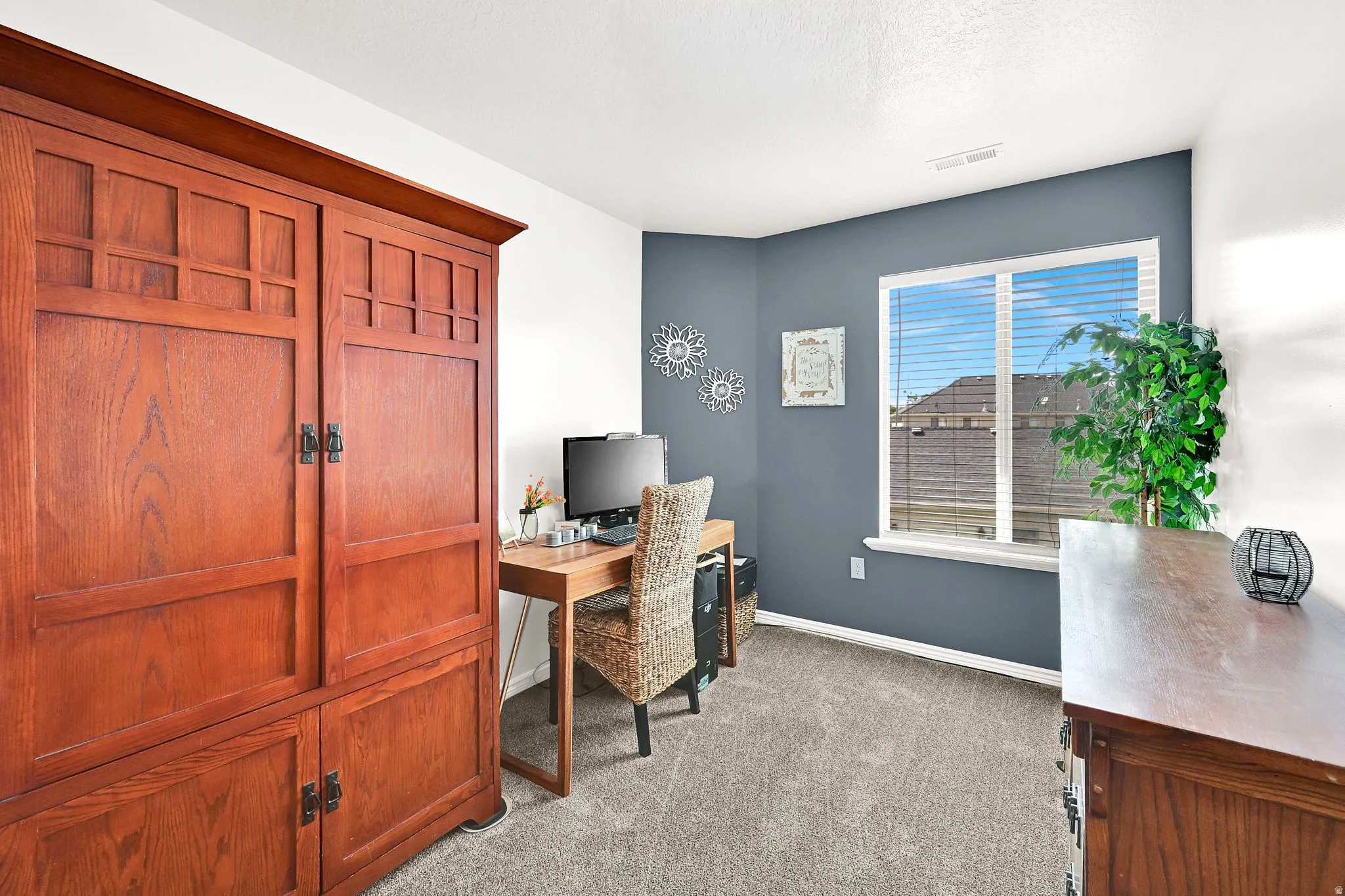 Recessed window with white blinds, carpeted flooring, and a wall with a contrasting accent color