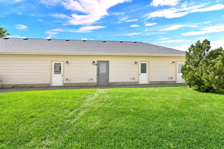 Exterior featuring horizontal siding, multiple entry doors with glass inserts, a shingled roof, and a concrete perimeter