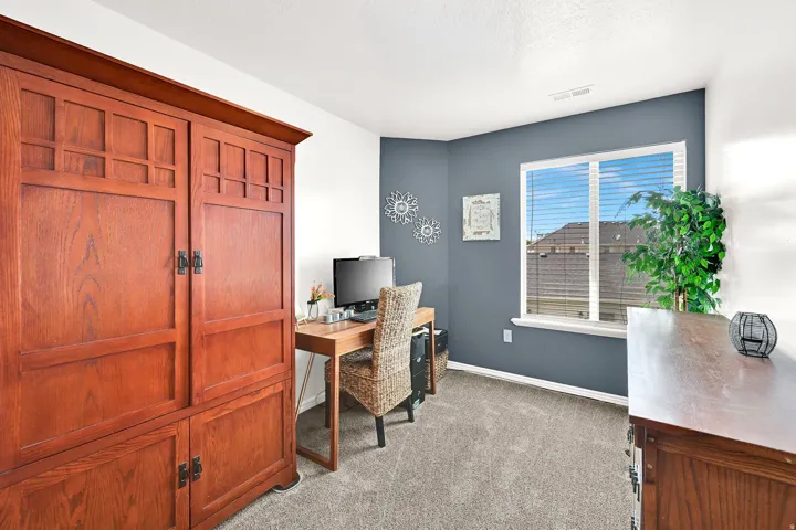 Recessed window with white blinds, carpeted flooring, and a wall with a contrasting accent color