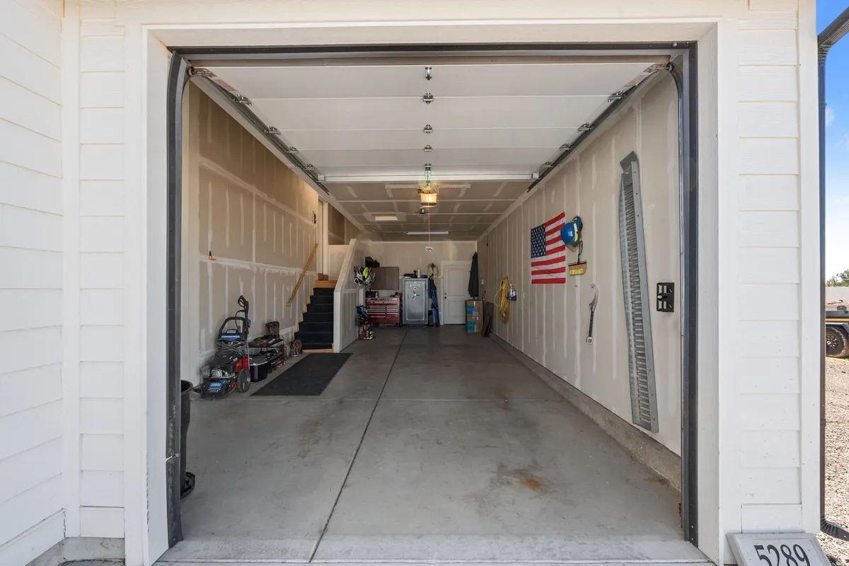 Open garage with concrete flooring