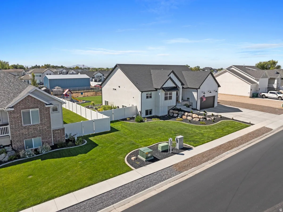 Modern farmhouse exterior with dark trim accents and white vertical siding