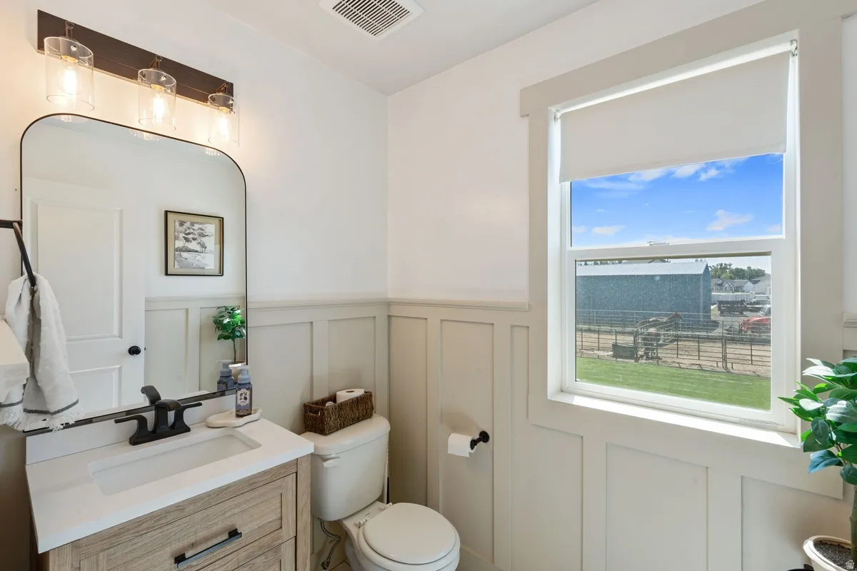 Modern vanity with wood-finish cabinetry, integrated sink, and matte black faucet