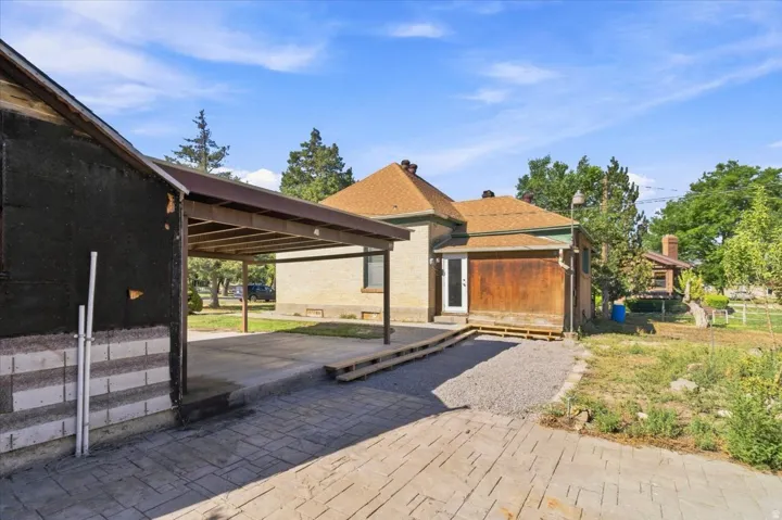 Carport structure with a stamped concrete driveway and gravel path