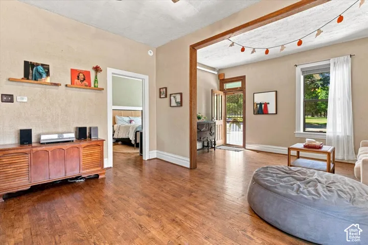Wood-finish flooring throughout, with a wood-frame entryway and a light-filled window
