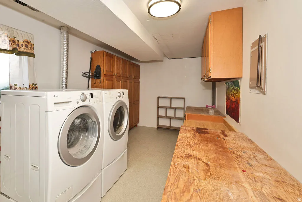 side B Laundry area featuring built-in cabinetry, a built-in countertop, and overhead lighting