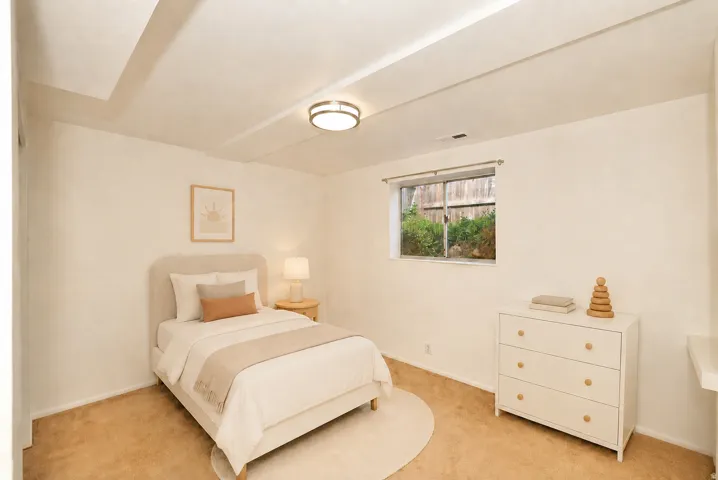Side B Recessed ceiling beams, neutral wall paint, carpet flooring, and a flush-mount ceiling light fixture