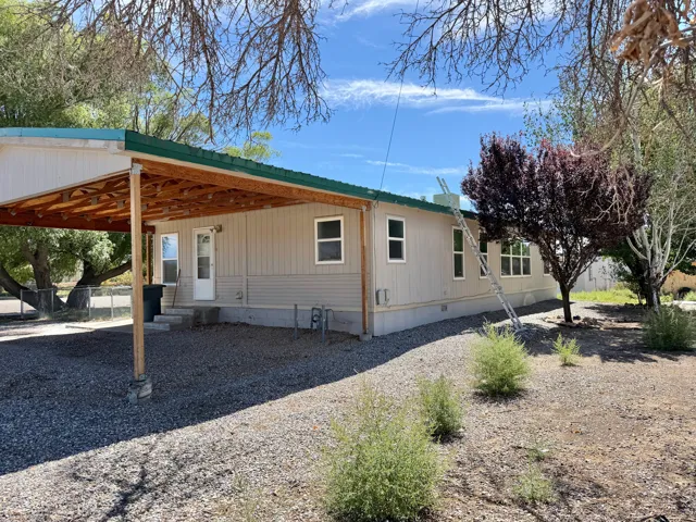 Expansive gravel yard with mature trees and established landscaping