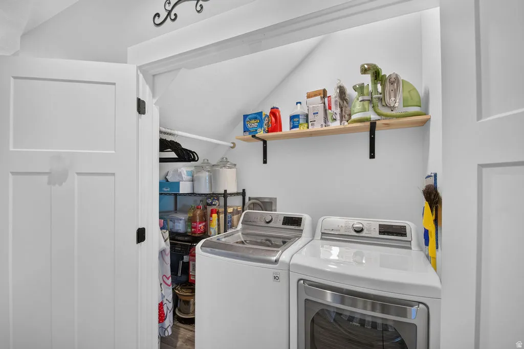 Dedicated laundry area with a wood-finish shelf and a clothes hanging rod