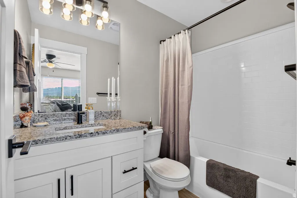 White vanity with black hardware, granite-style countertop, and rectangular undermount sink
