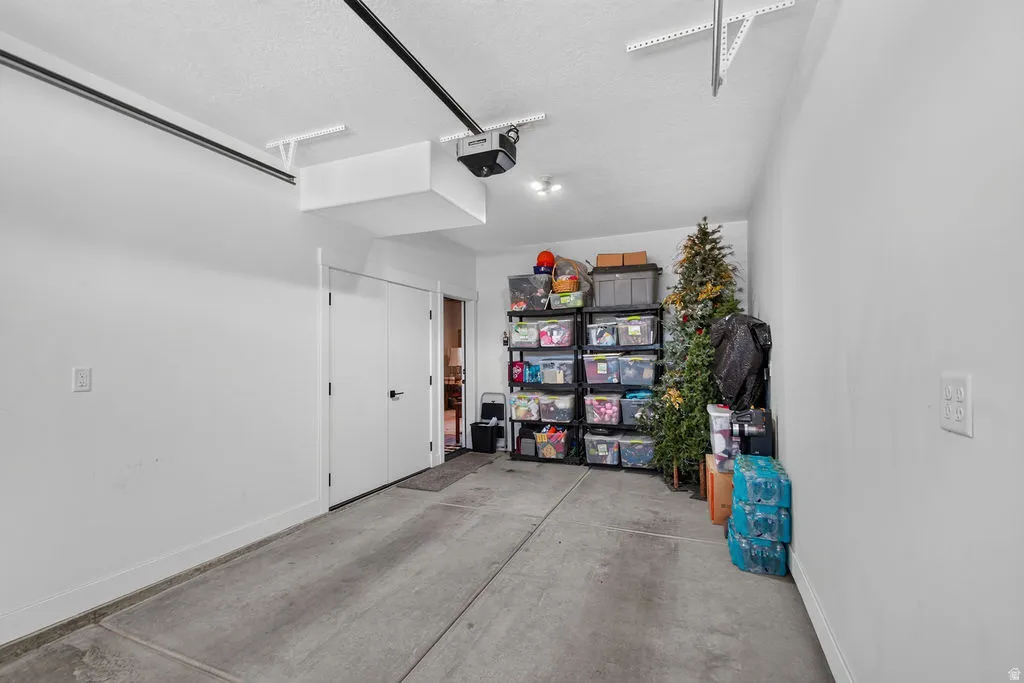 Concrete flooring with painted white walls and ceiling