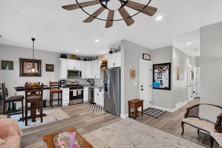 Kitchen featuring white cabinetry, stainless steel appliances, and a gas range