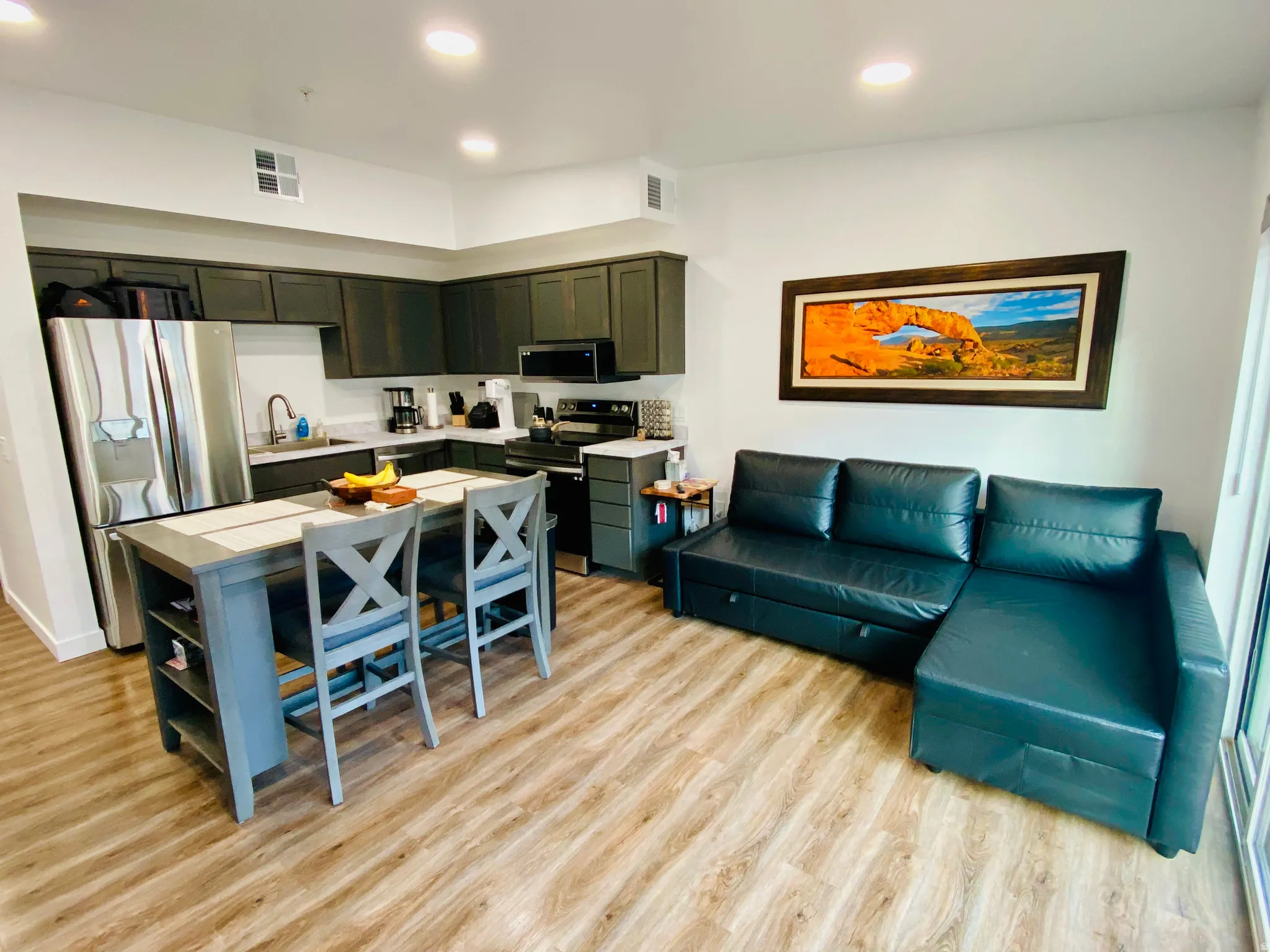Open-concept living space with wood-finish flooring