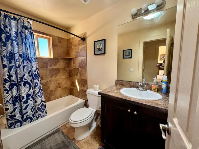 Vanity with an oval sink and a composite countertop