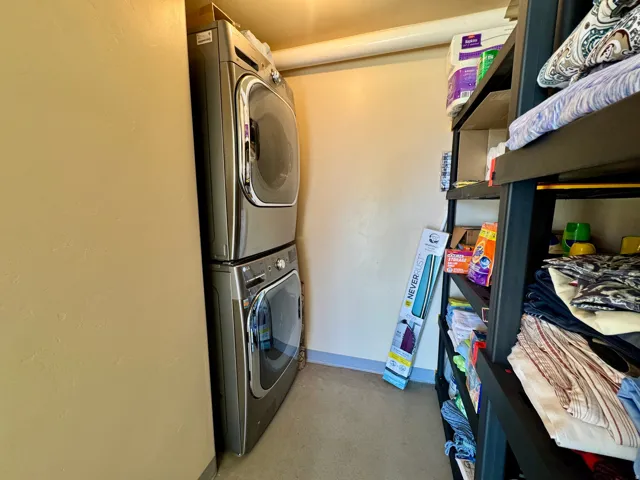 Stacked washer and dryer unit, and built-in shelving