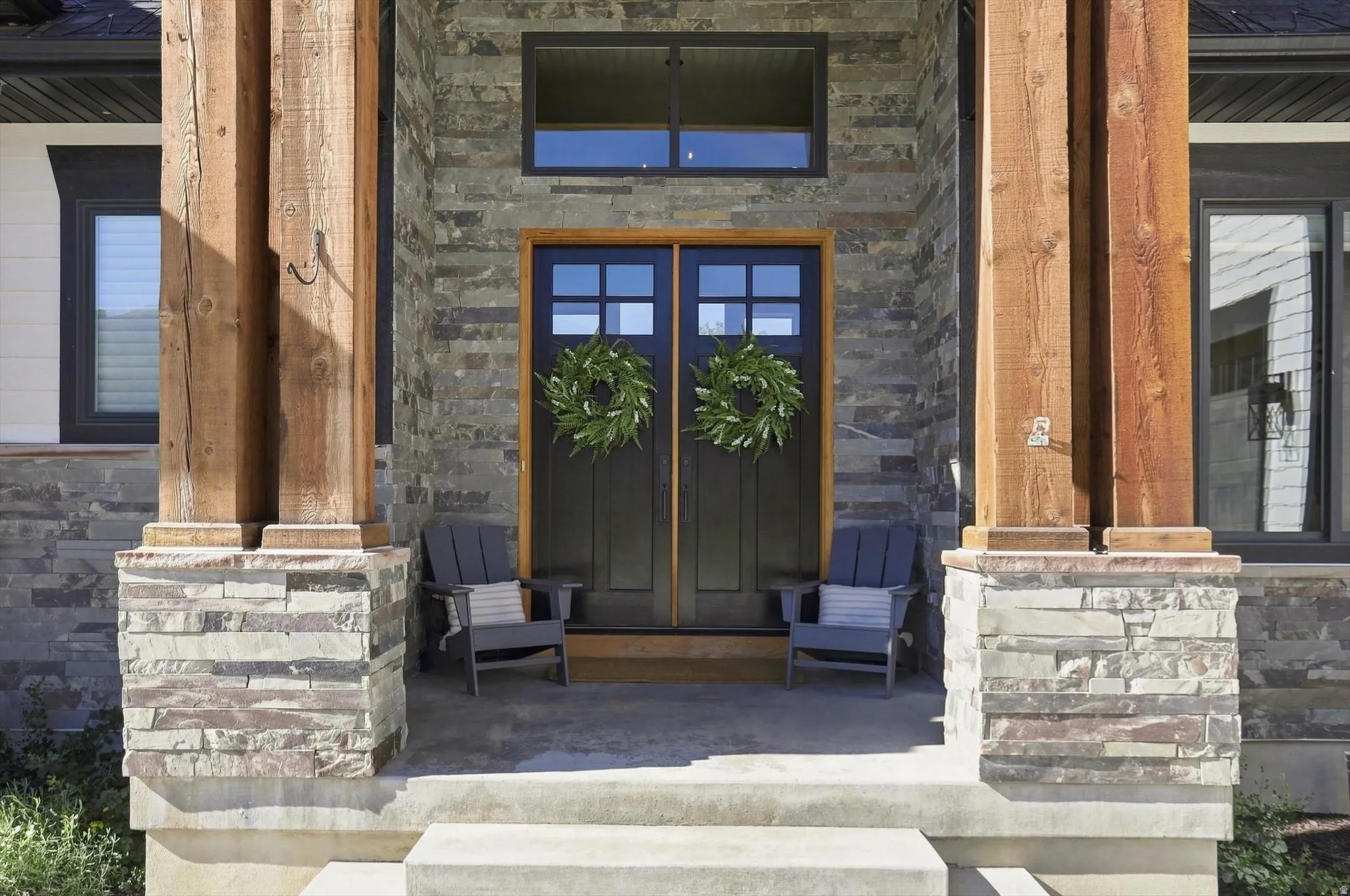 Stone façade featuring wood-clad pillars