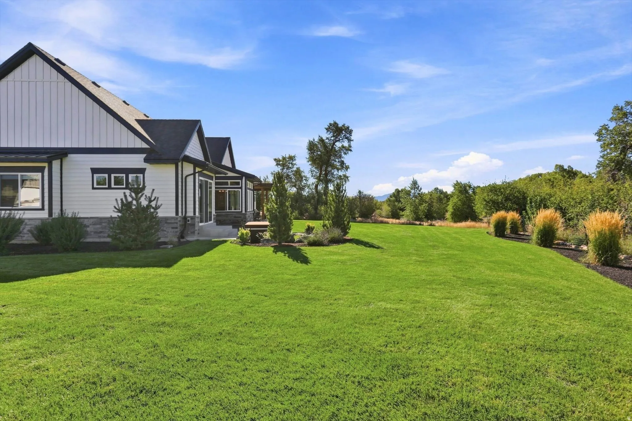 Expansive green space with landscaping and mature trees