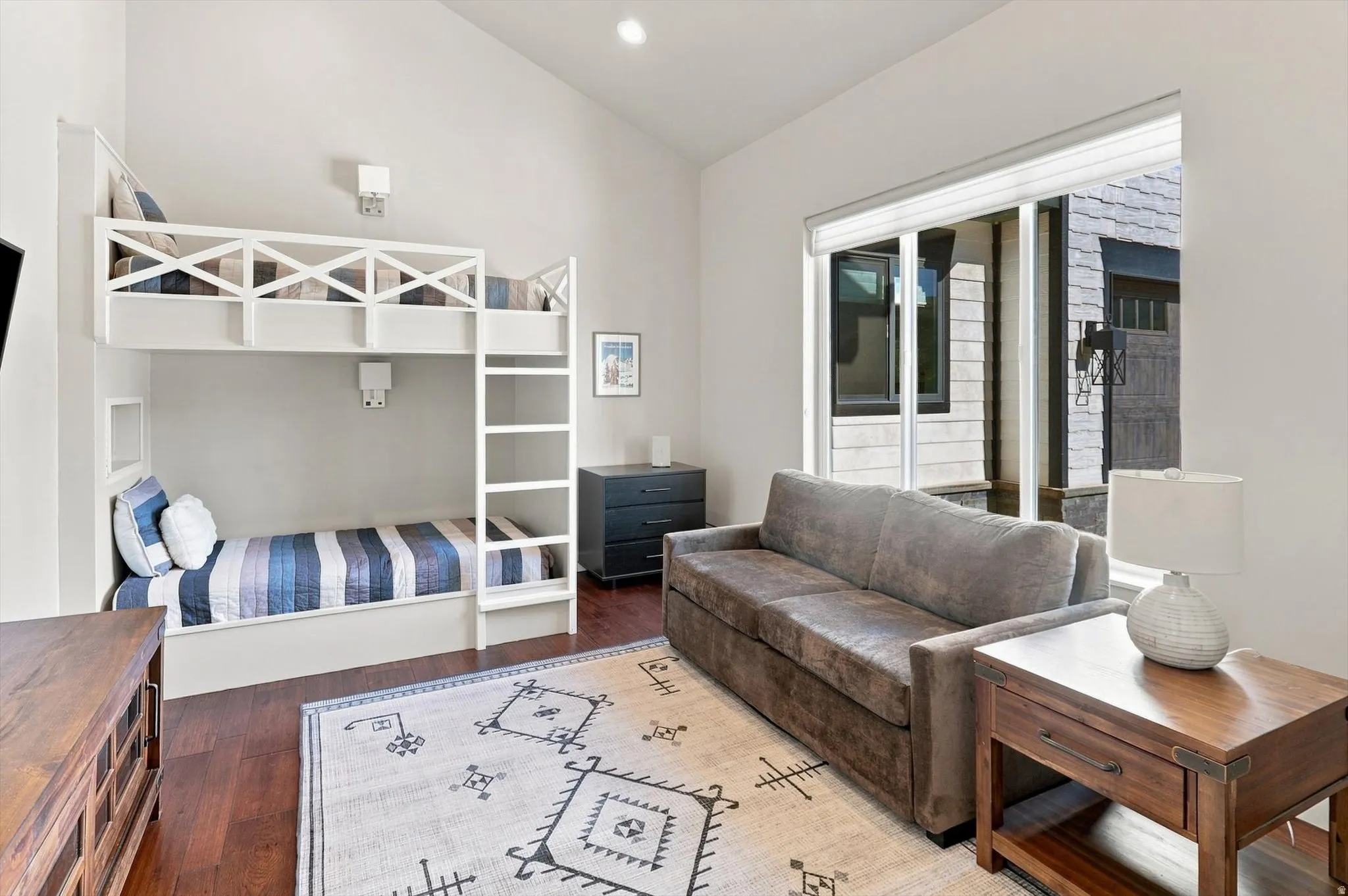 Built-in bunk beds with integrated ladder and wall sconces