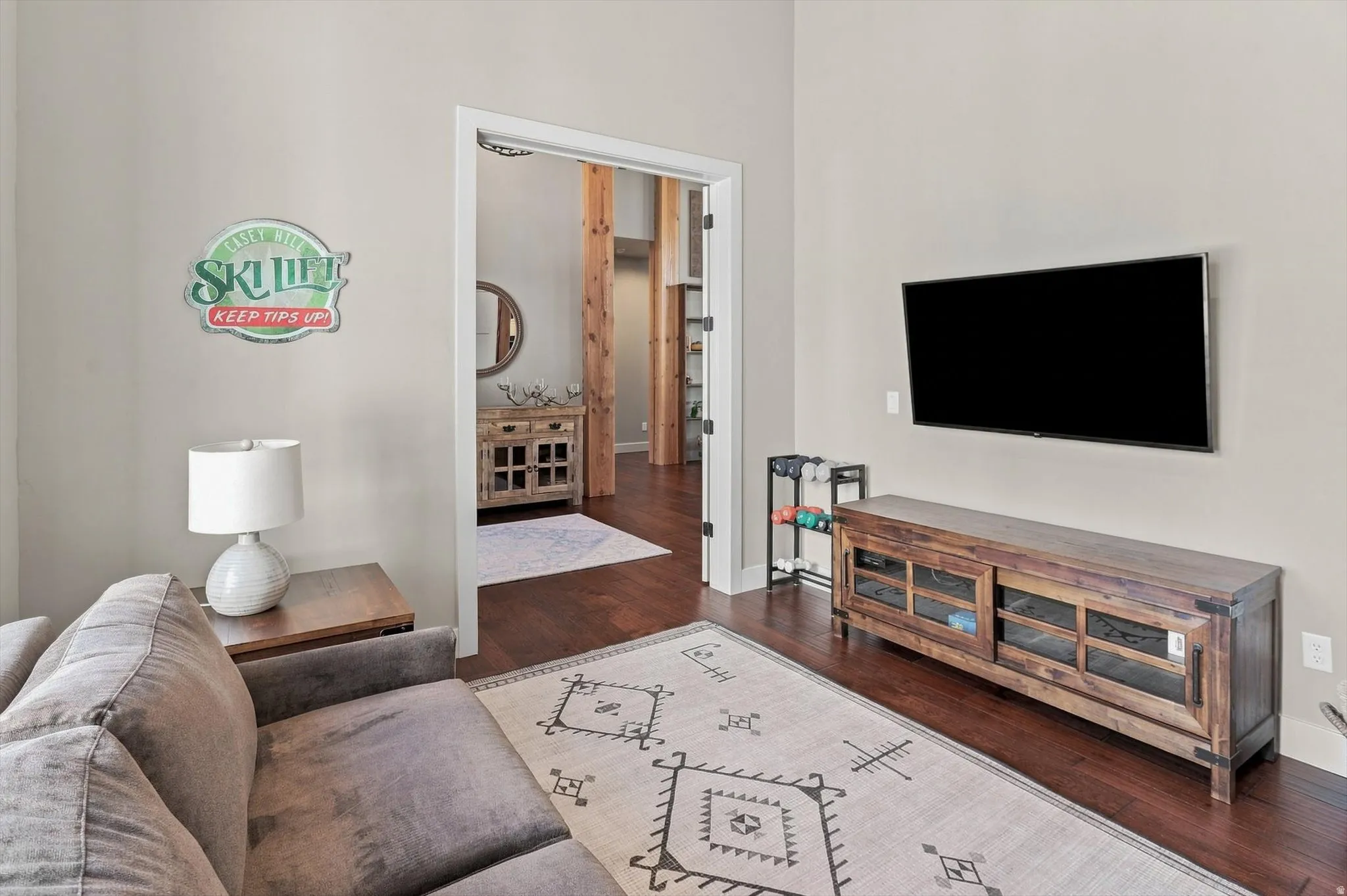 Rich wood-finish flooring complements neutral wall tones