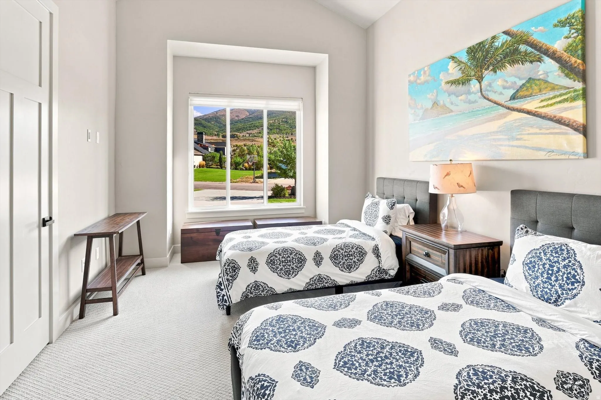 Vaulted ceilings complement light-toned wall finishes and textured carpeting