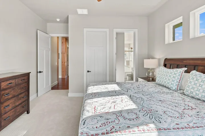 Plush carpeting, white paneled doors, recessed lighting, and dual upper windows
