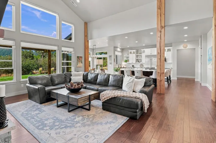 Vaulted ceilings, wood-finish flooring, exposed wood columns, ample fenestration, and recessed lighting
