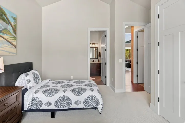 Vaulted ceilings, light neutral wall tones, and recessed lighting