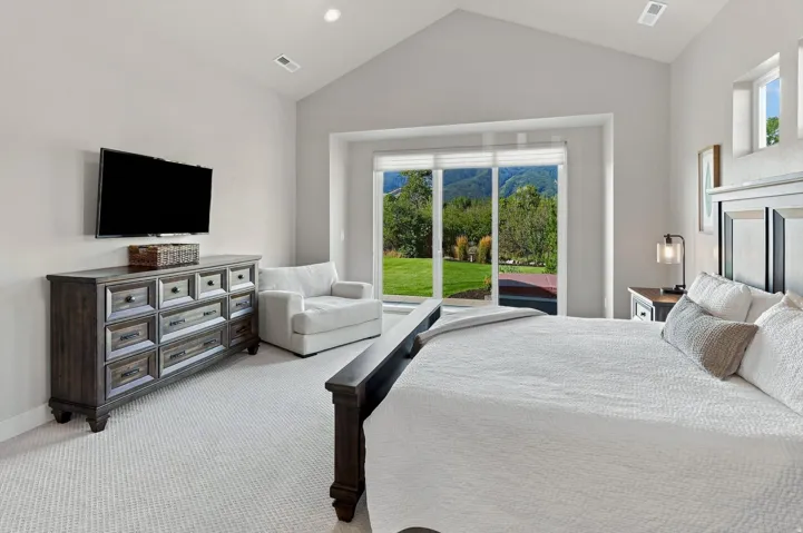 Vaulted ceilings, recessed lighting, carpet flooring, large sliding glass doors, and transom windows