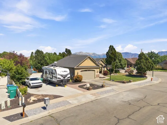 Attached garage with a tan exterior and stone accents
