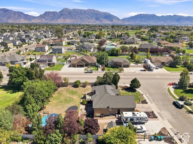 Mountain backdrop, residential neighborhood setting, broad street, established landscaping, cul-de-sac