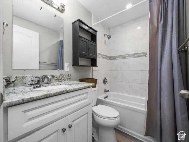 White vanity with a light-toned countertop and an undermount sink