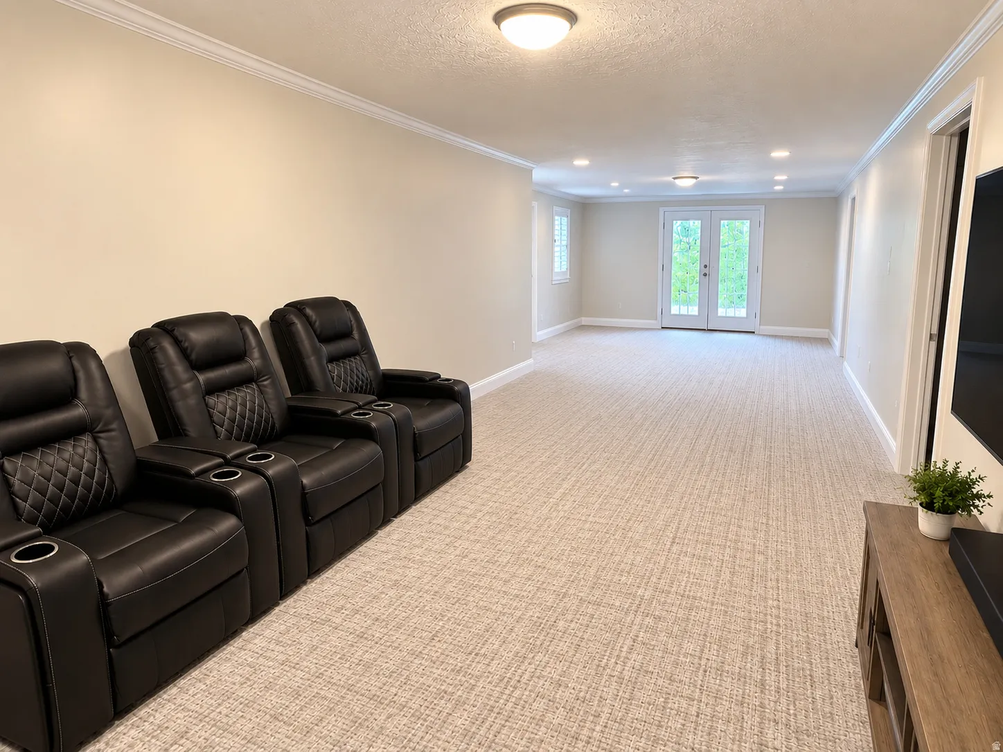 Spacious room featuring neutral carpeting, recessed lighting, and a double French door entry that opens to the backyard patio.