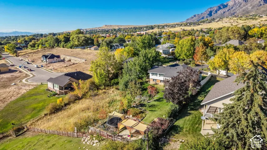 Residential property with mountain backdrop, neighborhood setting, and mature trees
